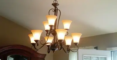 Classic ceiling chandelier installation with warm lighting in Louisville, KY