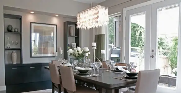 Elegant dining room chandelier installation above table in Louisville, KY