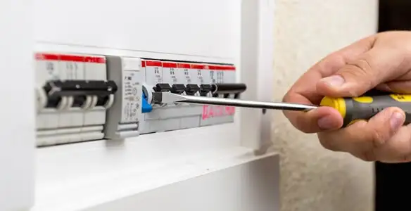 electrical panel upgrade service showing technician adjusting circuit breakers during system upgrade in Louisville, KY