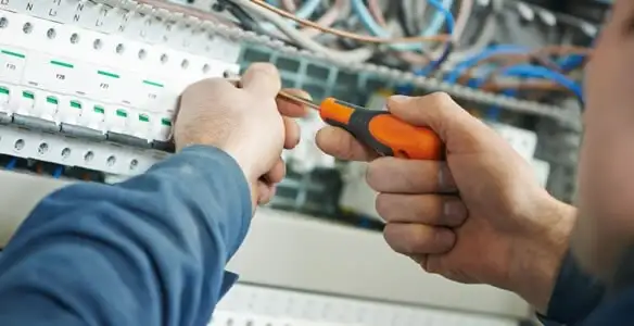 electrical service showing licensed electrician performing electrical panel maintenance and adjustments in Louisville, KY
