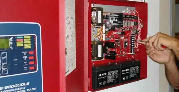fire alarm installation service showing technician configuring fire alarm control panel in Louisville, KY
