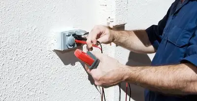 Electrician performing home electrical outlet and wiring inspection in Louisville, KY