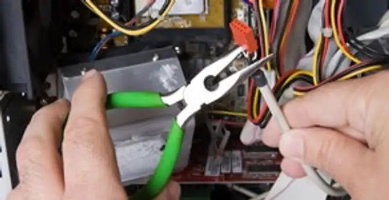 Licensed electrical contractor performing electrical repair with tools in New Albany, IN