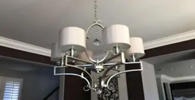 Modern chandelier installation with multiple light fixtures in Louisville, KY