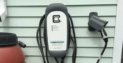 Outdoor electric vehicle charger installation on residential wall in Louisville, KY