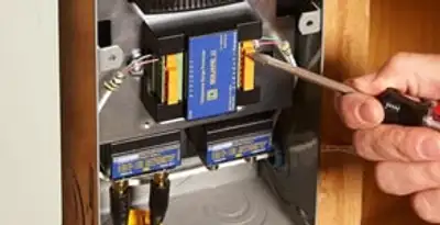 Whole home surge protection device being installed by a licensed electrician to protect electrical systems in Louisville, KY